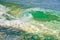 Beautiful transparent emerald wave swash on the beach on a sunny summer day