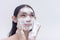 A beautiful transwoman washes her face with a foamy whitening facial cleanser. Beauty products and cosmetics endorser.