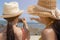 Beautiful traveler women or beautiful friend telling her friend to take beautiful photo at beautiful beach in summer season.