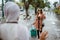 beautiful traveller with glasses waving her hand to her friend