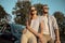 Beautiful Travelling Couple Resting on Car Hood