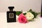 Beautiful and Trendy Perfume Sprayer on a White Table with Two Roses