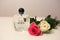 Beautiful and Trendy Perfume Sprayer on a White Table with Two Roses