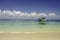 Beautiful tropical beach at Kapas Island, Malaysia. tourist boat anchored with blue sky background and crystal clear blue sea