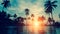 Beautiful tropical beach with palm trees silhouettes at dusk. Nature.