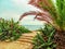 Beautiful tropical landscape of Altafulla beach in Catalonia Spain. Large aloe-cacti and palm tree against the background of the