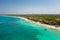 Beautiful tropical sandy exotic emerald paradise beach with sunbeds and sun umbrellas aerial view.