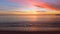 Beautiful tropical sunrise on the beach. Waves washing the sand on the bay