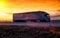 A beautiful truck with a trailer against the backdrop of an evening sunset before night. The concept of work and rest regime for