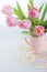 Beautiful tulips in a vase with decorative paper