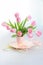 Beautiful tulips in a vase with decorative paper