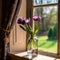 Beautiful tulips in a vintage glass jar on windowsill of old flat. Bouquet of fresh Bluebells flowers by a window. Art