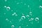 Beautiful turquoise background Rising air bubbles in clear water. Oxygen. Macro