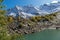 Beautiful turquoise lake in Dombay mountains, trekking in national park to the Alibek waterfall and glacier