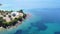 Beautiful turquoise sea and luxury beach house on the hill. Aerial view