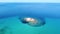 Beautiful turquoise transparent open sea under a bright blue sky and rocky island. Aerial view