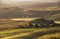 Beautiful Tuscany hills misty morning landscape view. Sunrise light covering the meadows and fields making a magic light-shadows