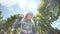 Beautiful twelve-year-old teenager girl posing and spinning in front of a video camera on the background of the summer