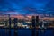 Beautiful twilight aerial drone photo of an oceanfront city backlit by purple sunset