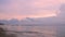 Beautiful twilight on sand beach with a little wave, and people relax on vacation