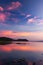 Beautiful twilight sky above a tropical lake, gently light pink clouds against the blue sky at dusk