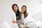 Beautiful two female LGBT lesbian embracing together in blanket cover body with love and romance on bed.Positive mood and moment