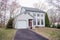 Beautiful two storey white house with trees and a white sky in the background