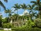 Beautiful two story white house with tall palm trees and picket fence in Key West Florida USA