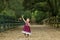 Beautiful two year old girl with a purple dress running and jumping with happiness