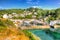 Beautiful UK harbour Polperro Cornwall England with clear blue and turquoise sea in vivid colour HDR like painting