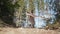 Beautiful ukrainian woman dancing with handkerchief in fir forest, Carpathian mountains nature. Girl in traditional