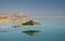 Beautiful umbrella reflection on dead sea beach