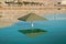 Beautiful umbrella reflection on dead sea beach