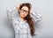 Beautiful unhappy puzzled woman in glasses holding the head on blue background. Closeup