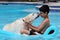 Beautiful unique golden retriever labrador dog and boy relaxing at the pool in a floating bed, dog super funny.