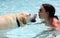 Beautiful unique golden retriever labrador dog and girl relaxing at the pool in a floating bed, dog super funny.