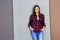 Beautiful urban woman, girl in jeans over bulding wall in three