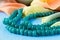 Beautiful valuable Emerald stone beads in on aquamarine backgrou
