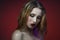 Beautiful vamp makeup woman with red lipstick red backgroun
