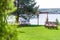 A beautiful venue for an open-air wedding ceremony. Wedding arch and rows of guest chairs on a green lawn overlooking the river