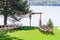 A beautiful venue for an open-air wedding ceremony. Wedding arch and rows of guest chairs on a green lawn overlooking the river