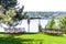 A beautiful venue for an open-air wedding ceremony. Wedding arch and rows of guest chairs on a green lawn overlooking the river