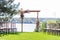 A beautiful venue for an open-air wedding ceremony. Wedding arch and rows of guest chairs on a green lawn overlooking the river