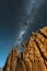 A beautiful vertical night sky landscape, with a yellow rock formation