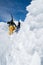 Beautiful vertical picture of skiers climbing the snowy mountain at daytime