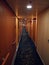 Beautiful vertical shot of a hallway with wooden cabin doors on both sides of it