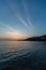 Beautiful vertical shot of the sun rising over the beach on a breezy autumn day in Lesbos, Greece