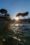 Beautiful vertical shot of the sun rising over the beach on a breezy autumn day in Samos