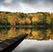 Beautiful vibrant Autumn woodland reflecions in calm lake waters