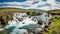 Beautiful vibrant summer panorama picture with a view on icelandic waterfall. Generative Ai